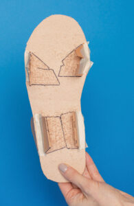 bottom of sole with tabs makred by black permanent marker